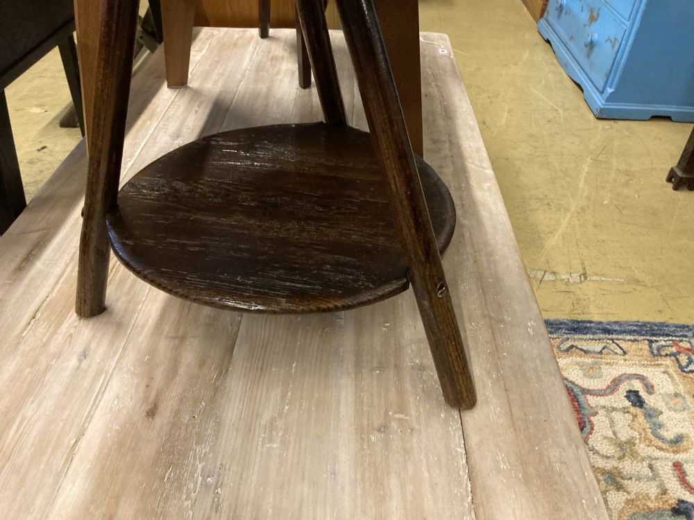 An 18th century pine cricket table, with undertier, 63cm diameter, height 56cm